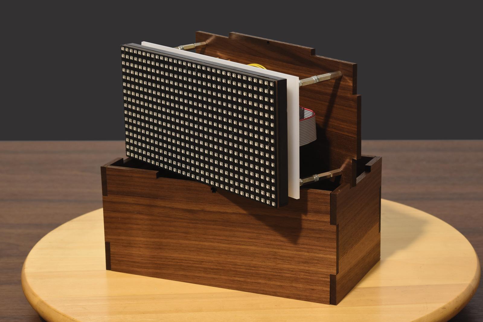 The display and circitry fit neatly within the laser-cut case.
